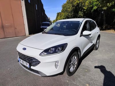 the white car is parked in the parking lot next to a building