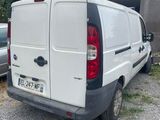 a white van that is parked in front of a building