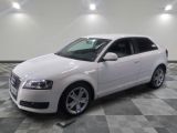 a picture of a white car parked in a garage