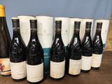 several bottles of wine are lined up on a table
