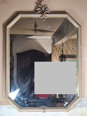 a mirror hanging on the wall above a sink