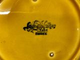 a yellow plate with a black logo on it