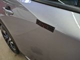 a close up of a car door with a sticker on it
