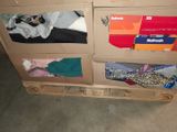 a cardboard box with clothes on top of it