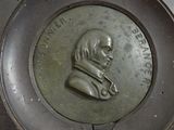 a metal plaque with a picture of a man on it