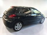 a picture of a small black car parked in a garage