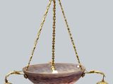 a close up of a hanging light fixture on a gray background