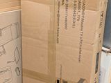 a cardboard box sitting on top of a pile of boxes