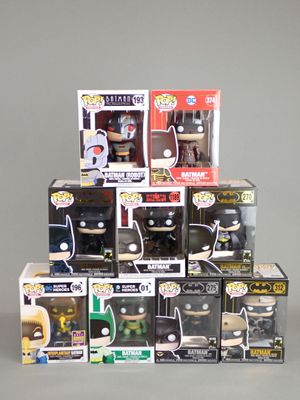 a pile of batman pop vinyl figures on a table