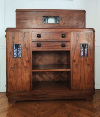 a wooden cabinet with a mirror on top of it