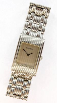 an image of a close up of a wrist watch on a white surface