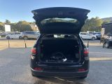 the back end of a car with its trunk open in a parking lot