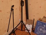 two tripod stands in the corner of a room with a blueprint