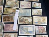 a lot of different types of paper money on a table