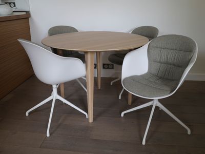 four chairs around a round table in a room
