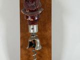 wooden wine bottle stopper with a wine cork and a bottle opener attached to it