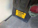 a yellow sticker on the back of a car