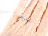 an image of a woman ' s hand with a diamond ring on it