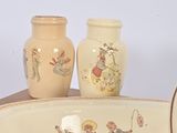 two vases and a bowl on a table