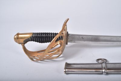 a sword that is laying on the ground next to a piece of metal