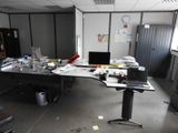 a desk that has a laptop on it in the middle of a room