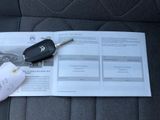 a car key sitting on top of a piece of paper on a car seat