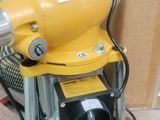 a yellow blower sitting on top of a wooden floor