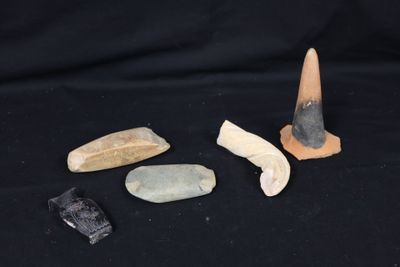 several different types of rocks and stones on a black background