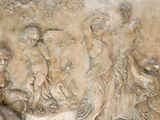 a relief of a group of people on a wall
