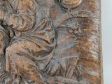 a relief of a man and a woman sitting on a bench