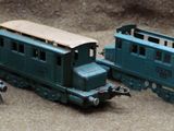 several toy trains are lined up in a row on the ground