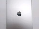 an apple ipad sitting on top of a table next to a white wall