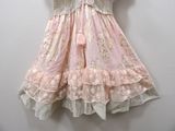 a pink dress hanging on a white wall