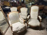 several chairs and a mirror in a room with a lot of furniture