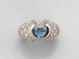 a ring with a blue topaz stone surrounded by white diamonds