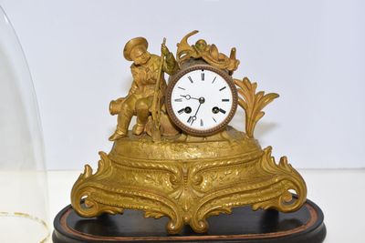 PENDULE en régule doré surmonté d'un marin et d'une ancre, s…