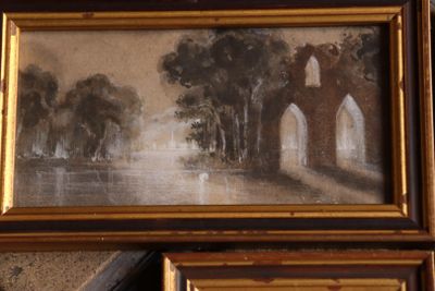 a picture of a painting hanging on a wall next to a pair of framed pictures