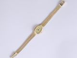 a close up of a watch on a white surface with a white background