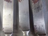three knives that are sitting next to each other on a table