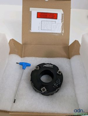 une boîte contenant un bout de papier et un outil