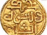 a close up of a gold coin with a design on it