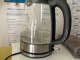 a tea kettle sitting on top of a washing machine