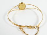 gold bracelet with a heart charm and a chain on a white background