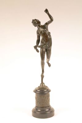 bronze statue of a woman holding a bird on a pedestal