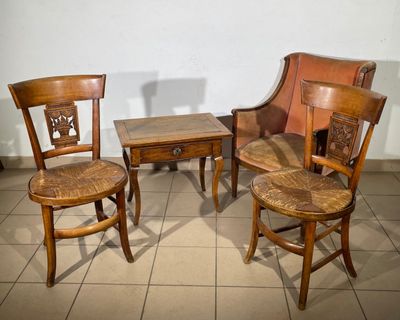 three wooden chairs and a table on a tiled floor