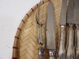 a lot of silverware on a wicker basket on the table