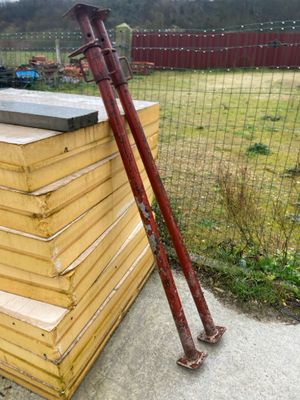 a pile of wood and a baseball bat on the ground