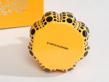a yellow box with a black polka dot design on it