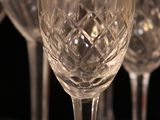 several empty wine glasses sitting on top of each other on a table