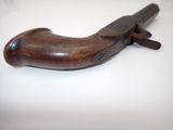 a wooden pipe cutter on a white surface
